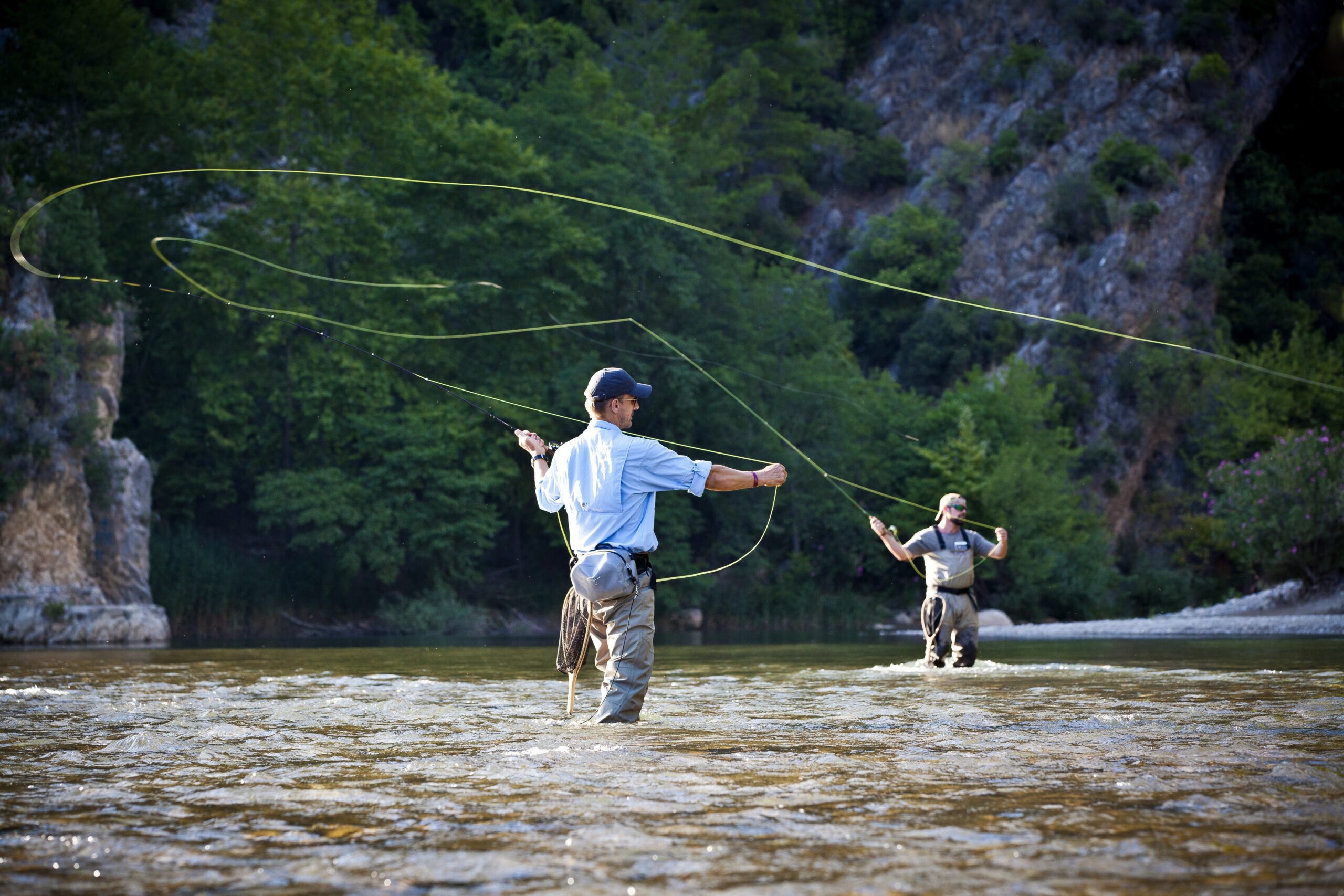 Anglers fly fishing in a mountain river