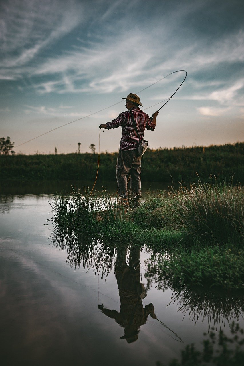 Angler fly fishing beside calm water, representing the Did You Fish mission