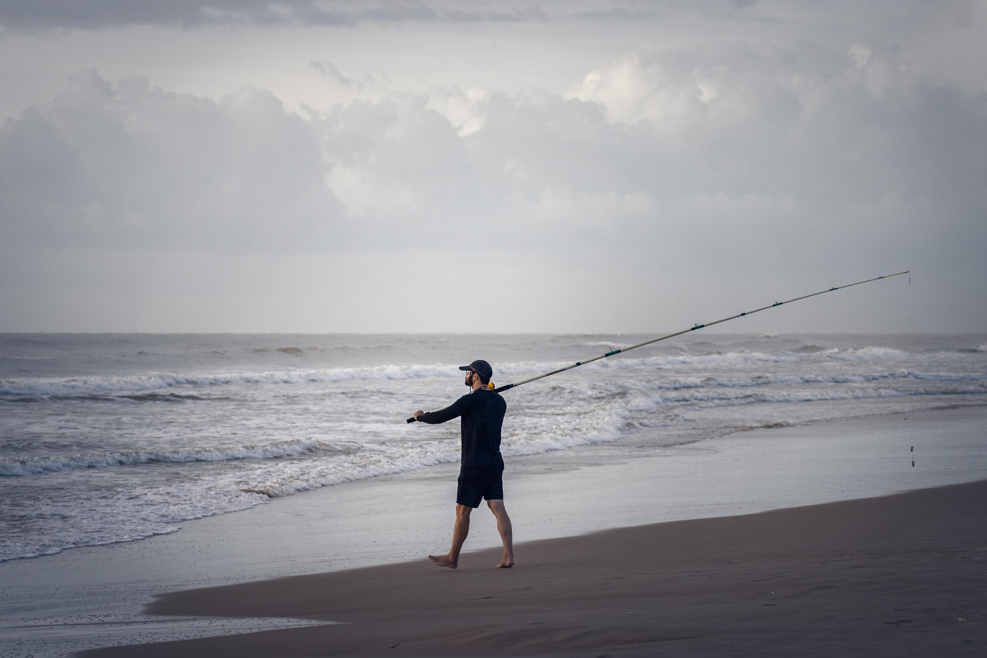 Angler surf fishing on the beach for the Wrightsville Beach fishing report