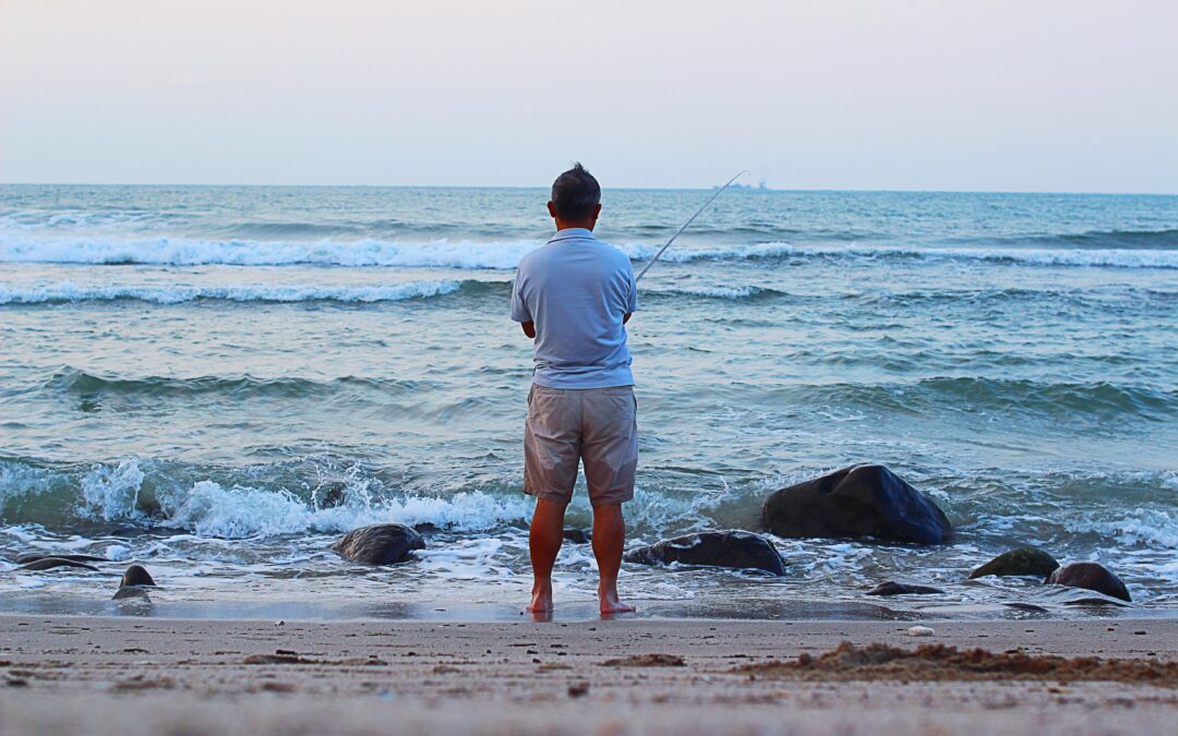 Angler surf fishing for pompano on a North Carolina beach